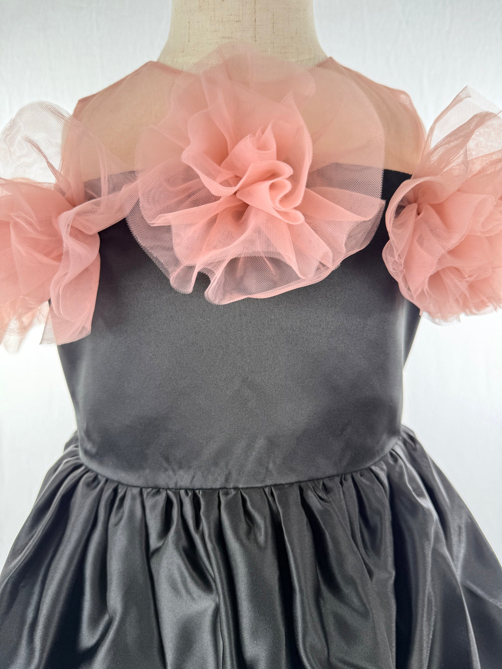 Closeup of black satin tulle girls party dress, suitable for birthdays, weddings, parties, photoshoots and special occasions