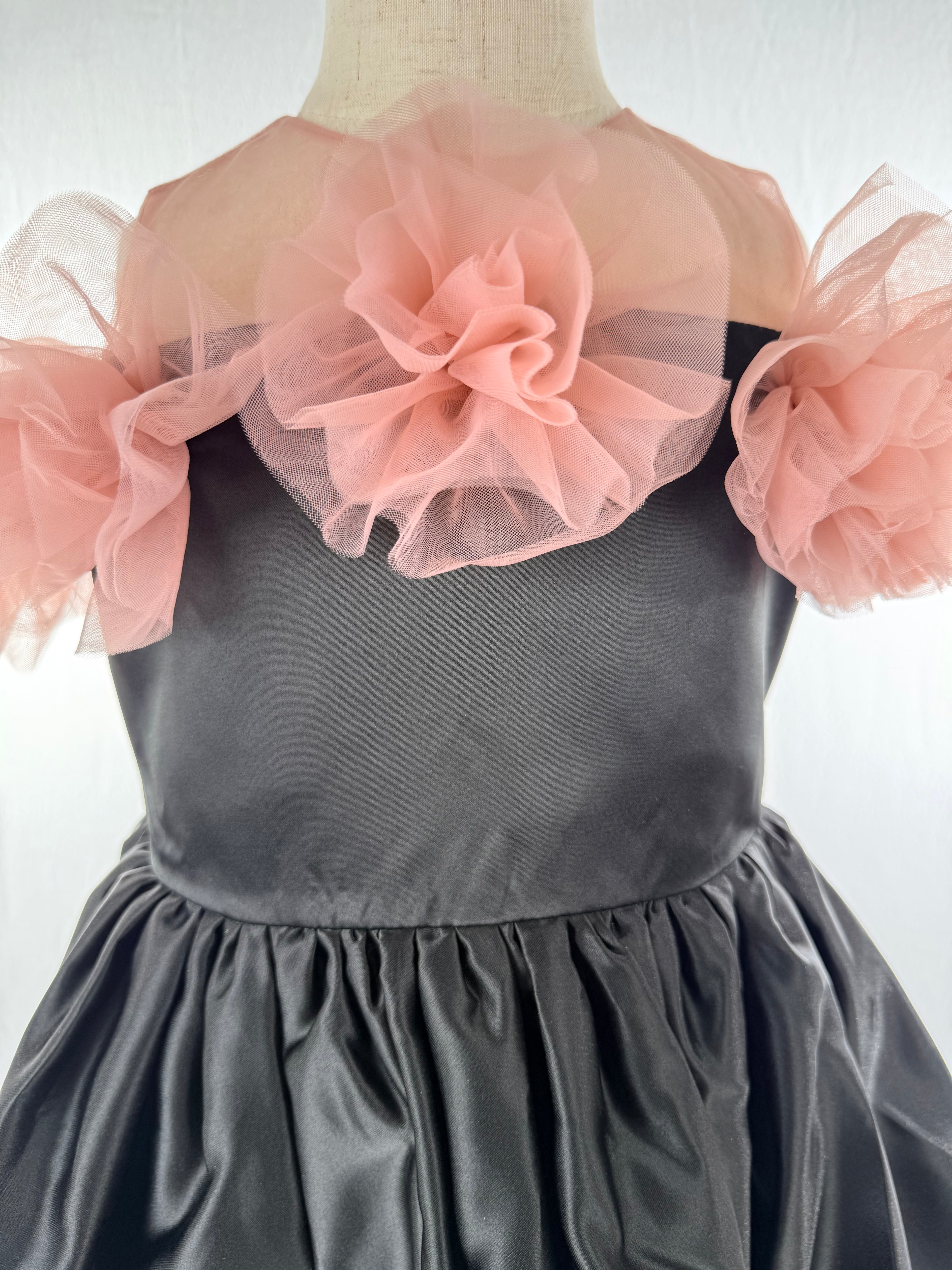 Closeup of black satin tulle girls party dress, suitable for birthdays, weddings, parties, photoshoots and special occasions