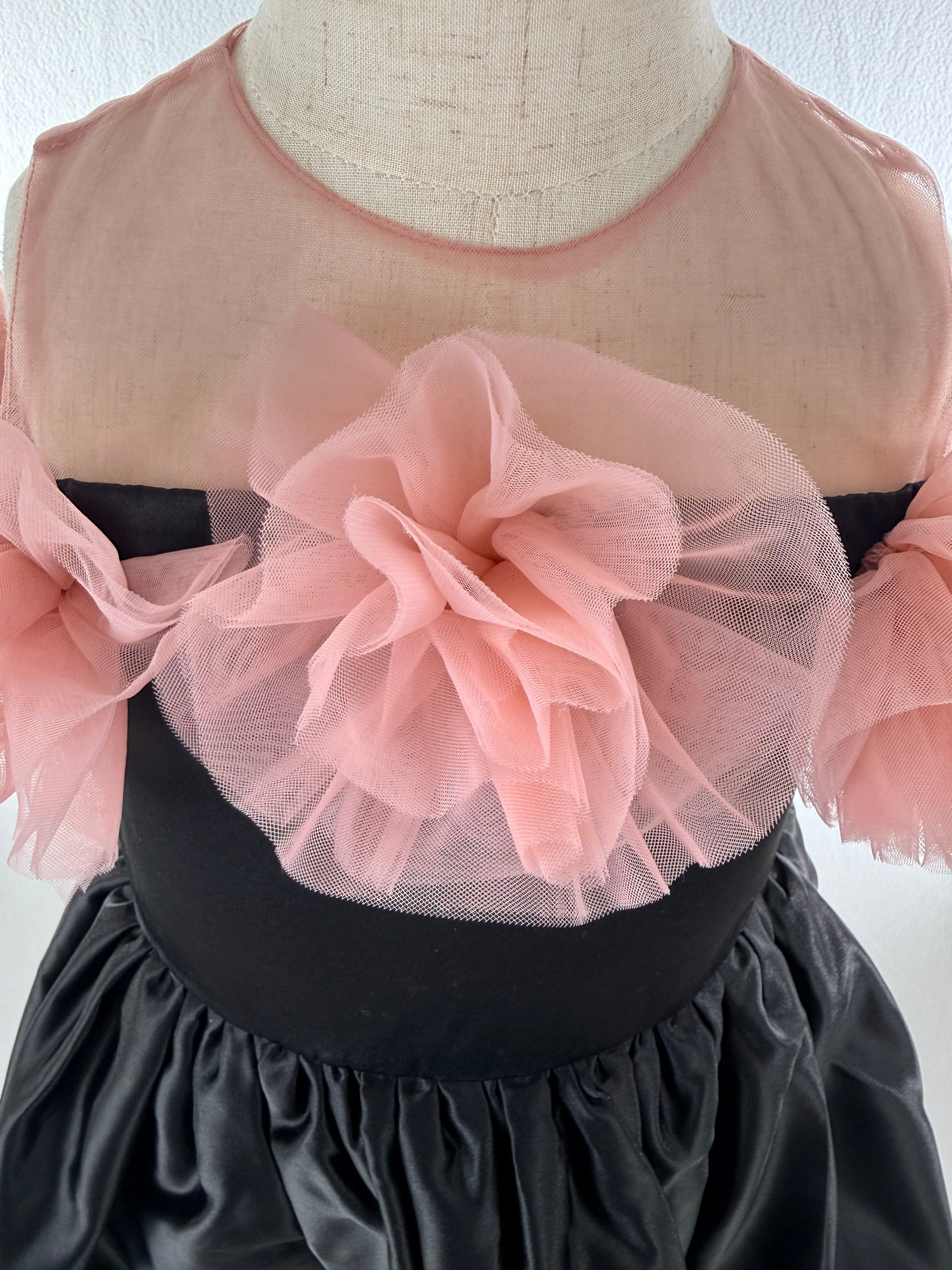 Closeup of black satin tulle girls party dress, suitable for birthdays, weddings, parties, photoshoots and special occasions