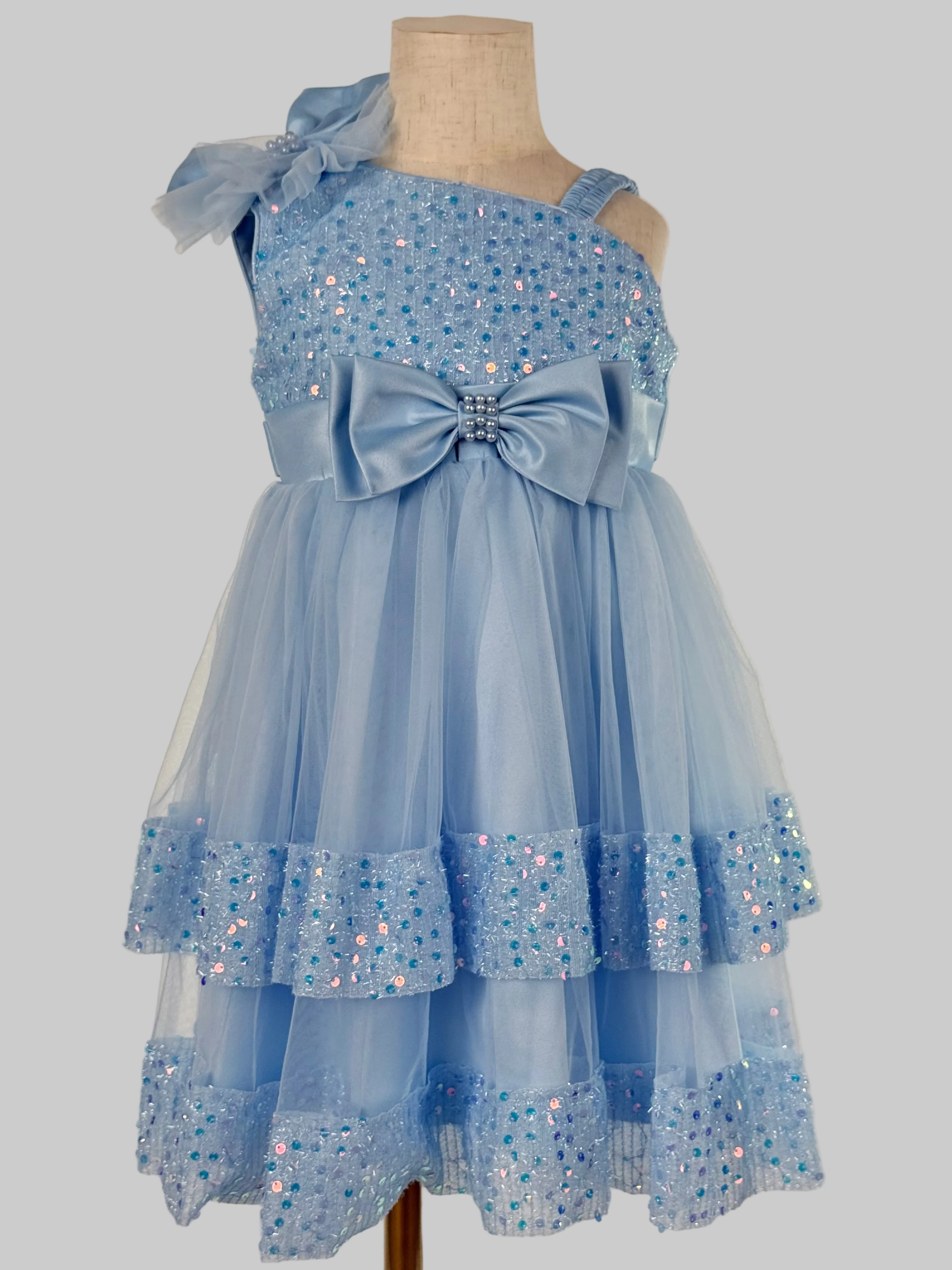Front view of light blue tulle sequin one shoulder girls party dress, suitable for  birthdays, flower girls, photo shoots, formal occasions