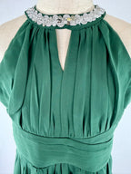 Closeup of green halter neck chiffon girls party dress, suitable for birthdays, bridesmaids, and formal occasions