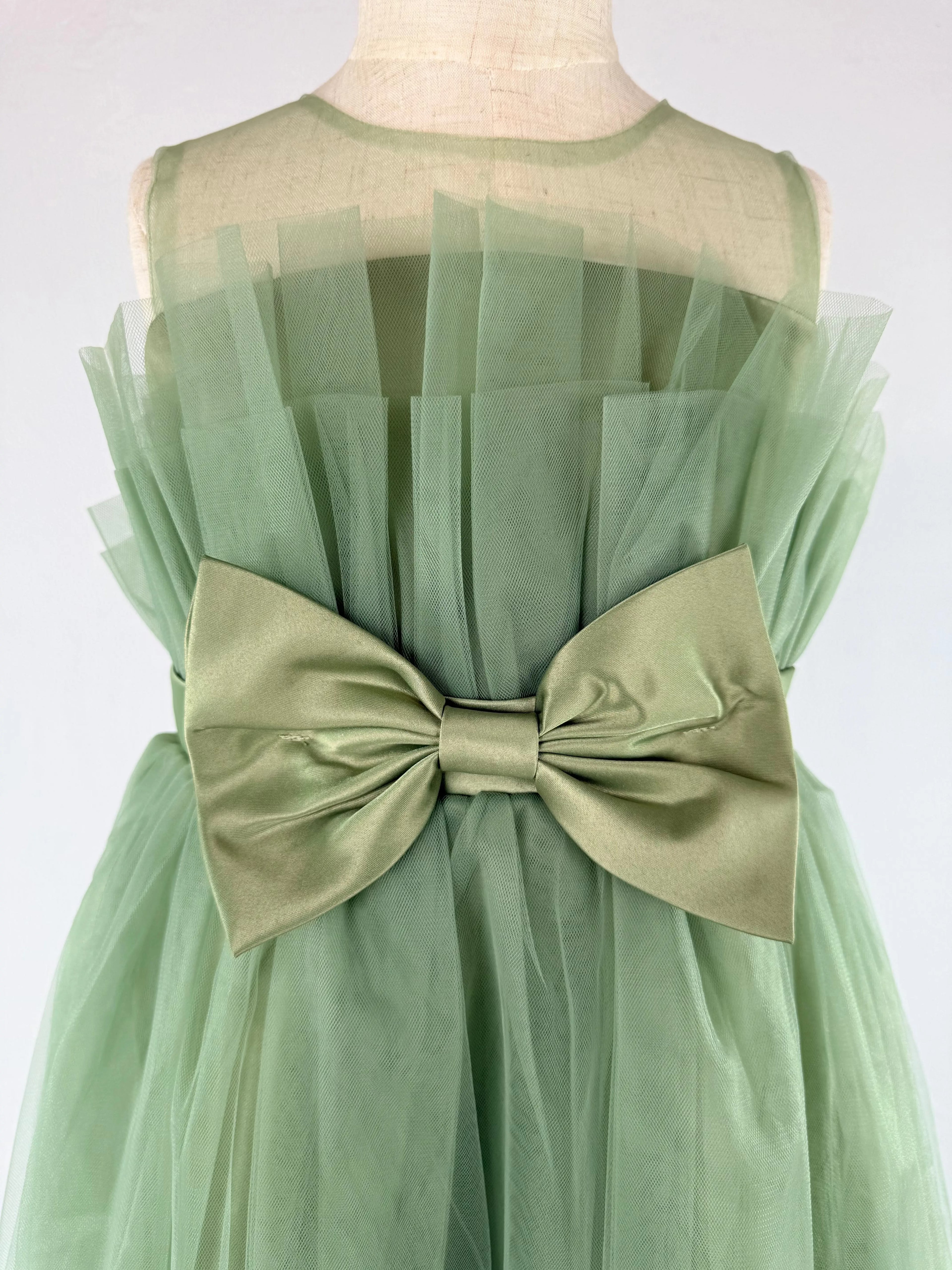 Closeup of sage green net tulle girls party dress, suitable for birthdays, flower girls, and formal occasions