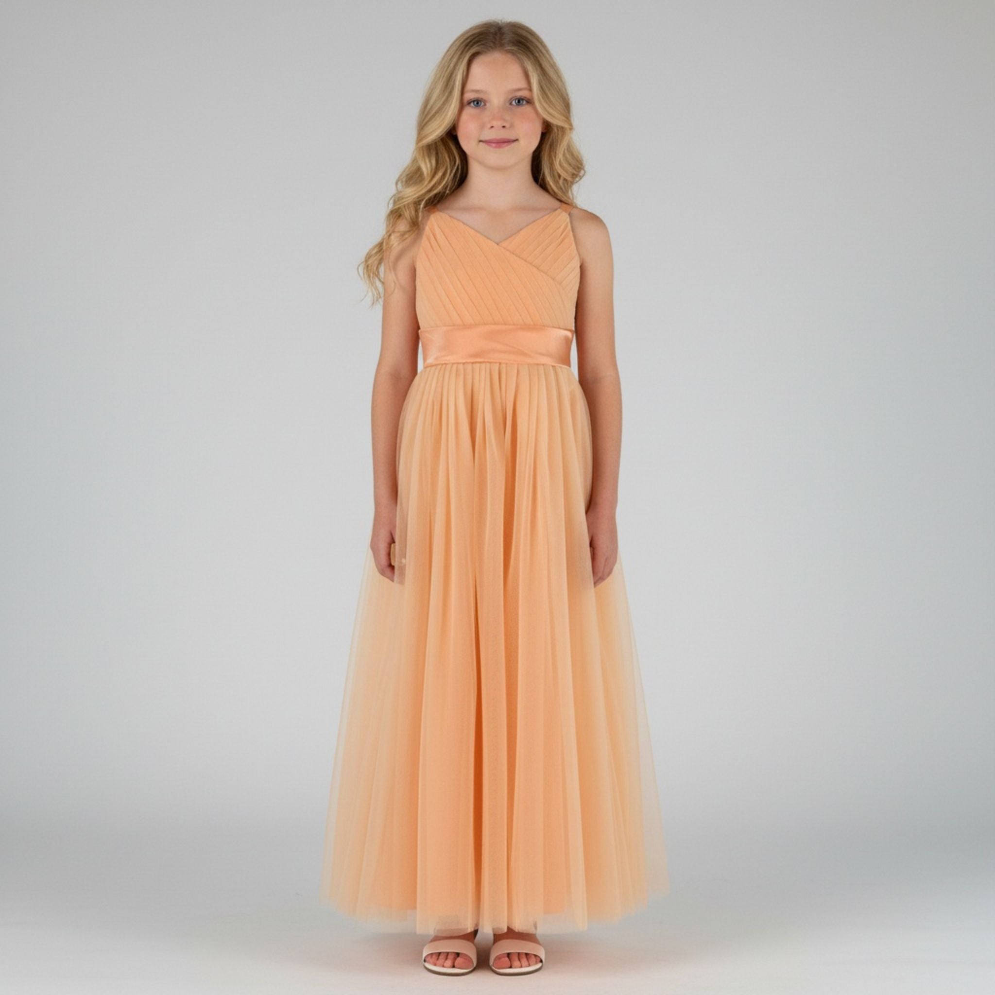Front view of peach net tulle girls party dress, suitable for birthdays, flower girls, and formal occasions