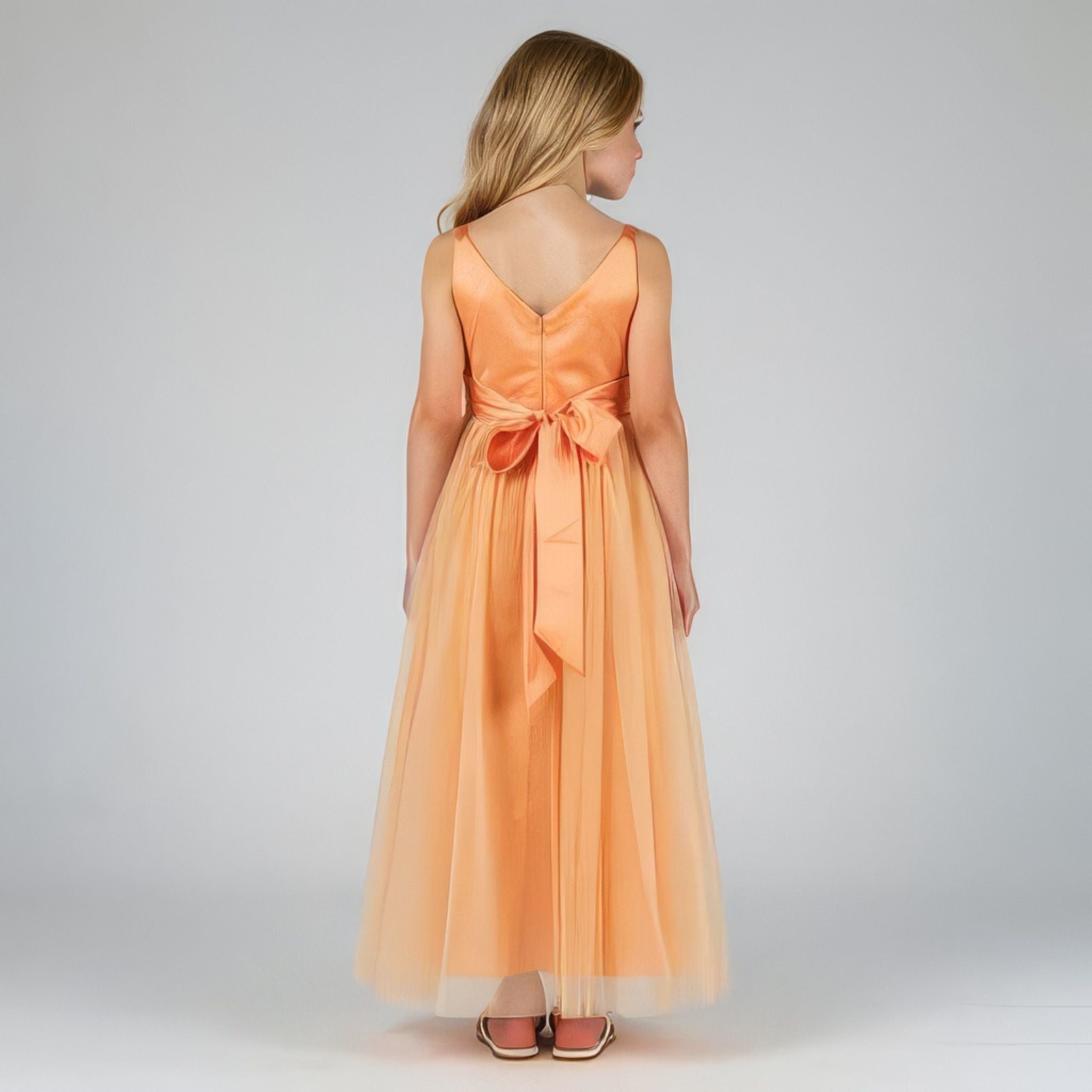 Back view of peach net tulle girls party dress, suitable for birthdays, flower girls, and formal occasions
