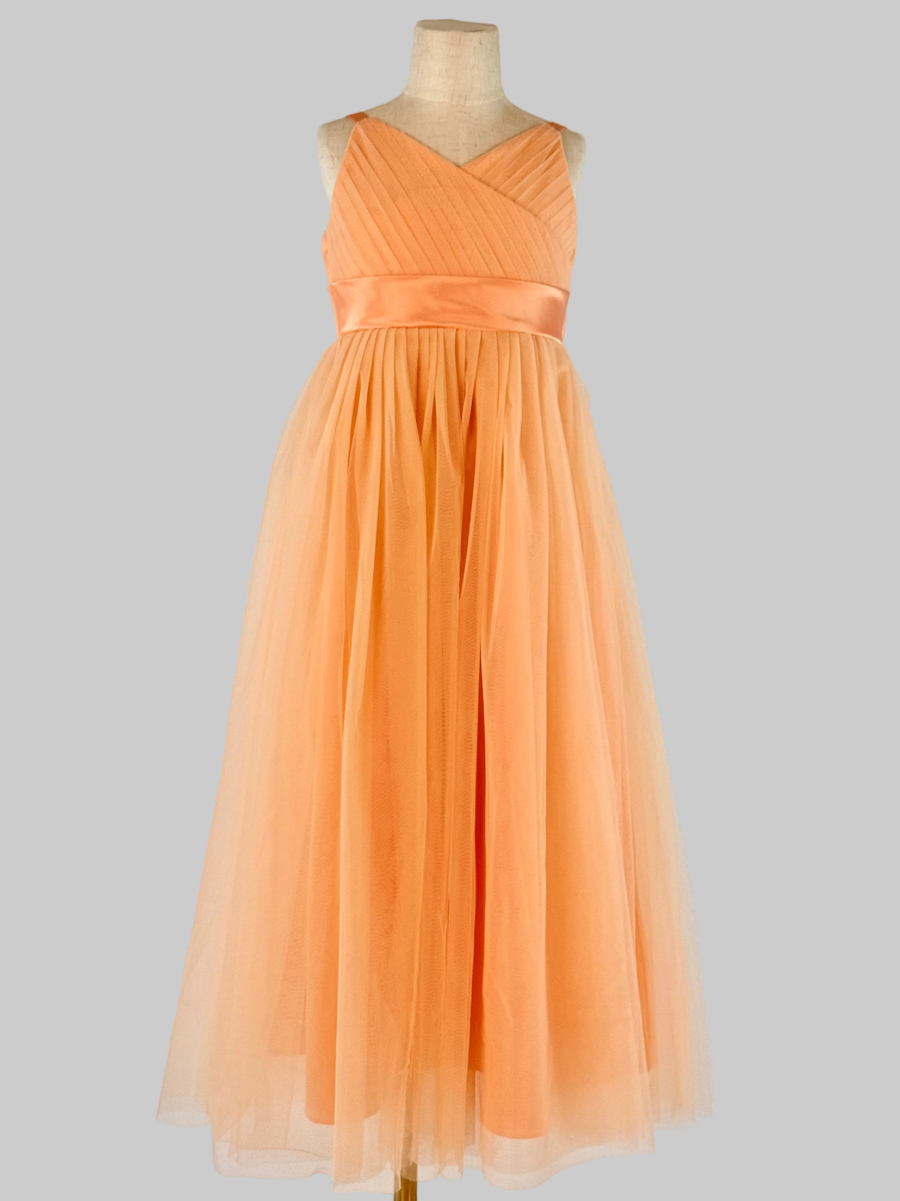 Front view of peach net tulle girls party dress, suitable for birthdays, flower girls, and formal occasions