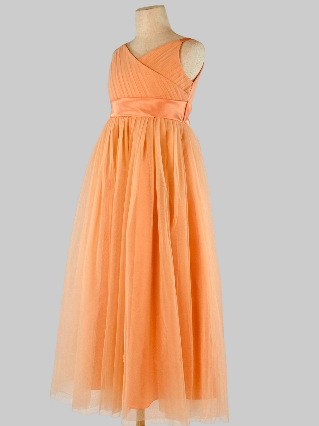 Side view of peach net tulle girls party dress, suitable for birthdays, flower girls, and formal occasions