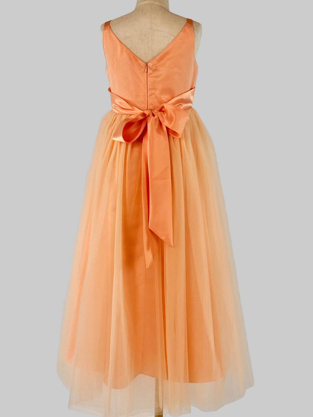 Back view of peach net tulle girls party dress, suitable for birthdays, flower girls, and formal occasions