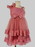 Front view of blush pink tulle sequin one shoulder girls party dress, suitable for  birthdays, flower girls, photo shoots, formal occasions