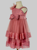 Side view of blush pink tulle sequin one shoulder girls party dress, suitable for  birthdays, flower girls, photo shoots, formal occasions