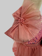 Closeup of blush pink tulle sequin one shoulder girls party dress, suitable for  birthdays, flower girls, photo shoots, formal occasions