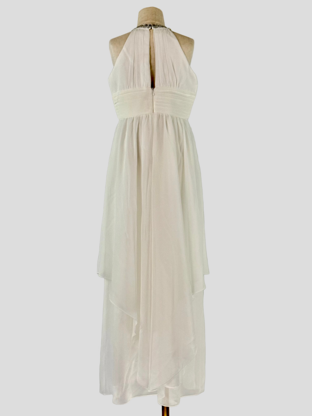 Back view of white halter neck chiffon girls party dress, suitable for birthdays, bridesmaids, and formal occasions