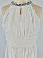 Closeup of white halter neck chiffon girls party dress, suitable for birthdays, bridesmaids, and formal occasions
