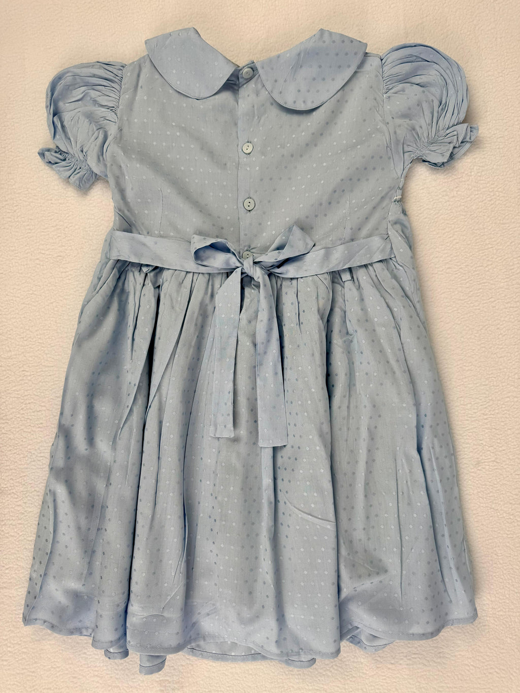 Back view of blue smocked dress. Suitable for birthdays, family gatherings, special occasions, or everyday.