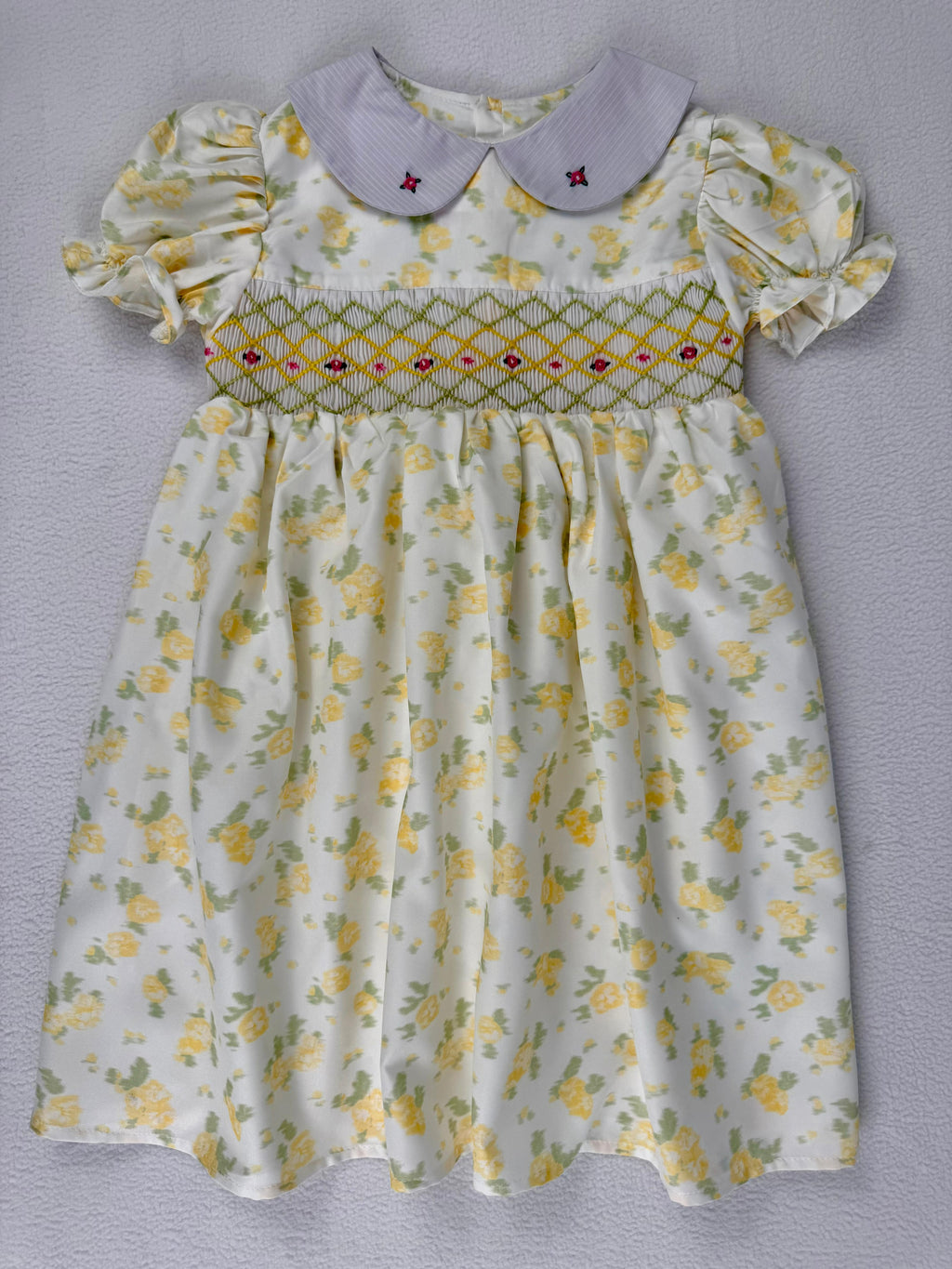Front view of yellow floral smocked dress. Suitable for birthdays, family gatherings, special occasions, or everyday.