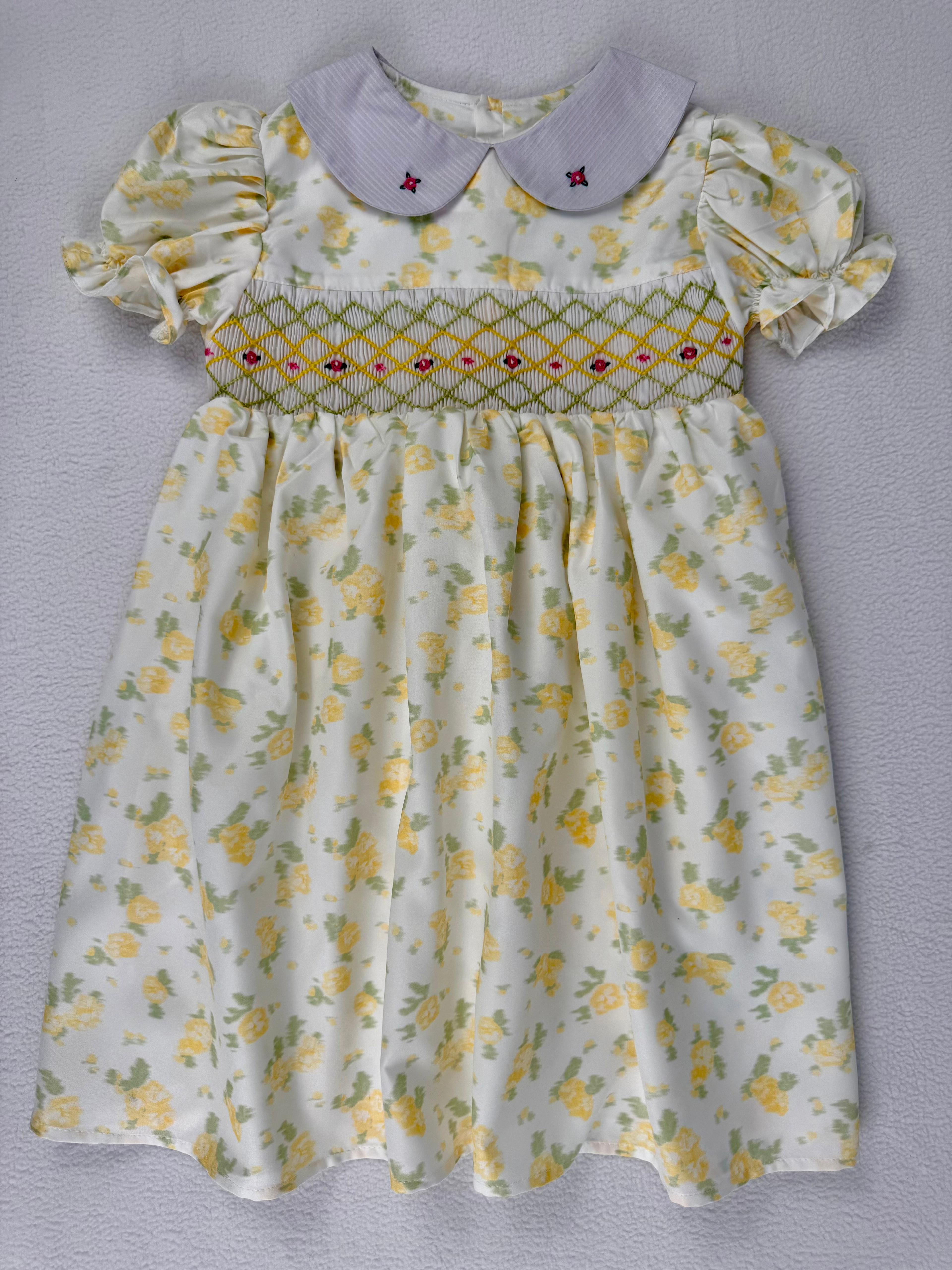 Front view of yellow floral smocked dress. Suitable for birthdays, family gatherings, special occasions, or everyday.