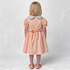 Back view of peach smocked dress. Suitable for birthdays, family gatherings, special occasions, or everyday.