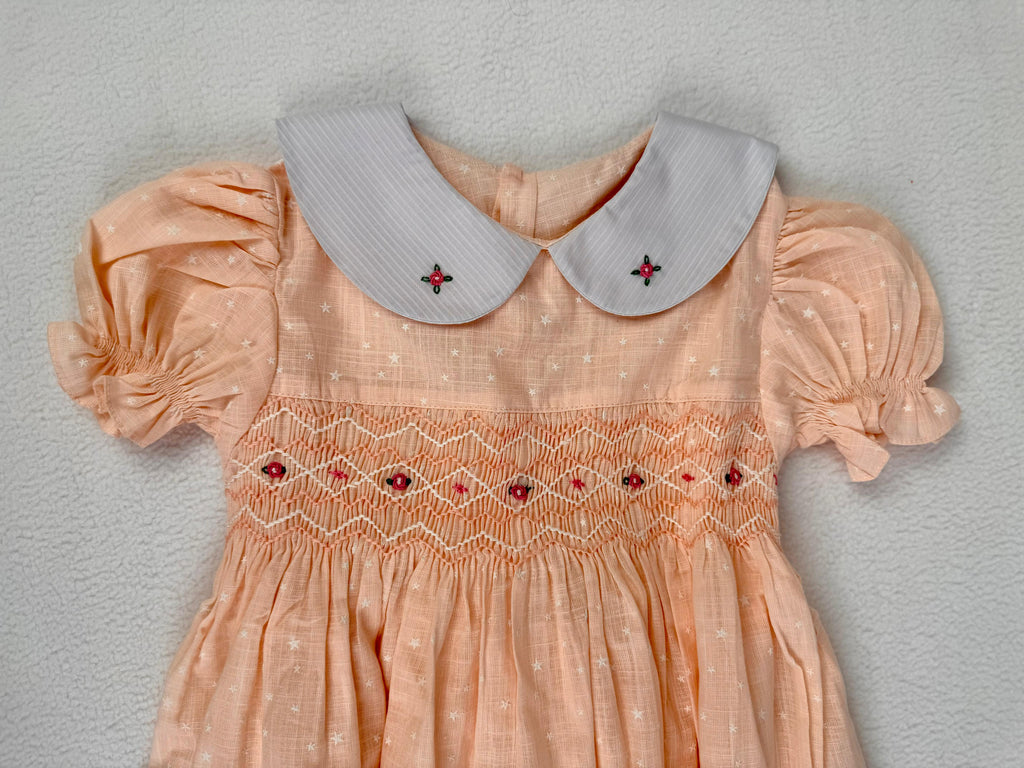 Close up of peach smocked dress. Suitable for birthdays, family gatherings, special occasions, or everyday.