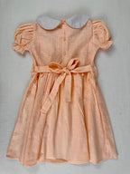 Back view of peach smocked dress. Suitable for birthdays, family gatherings, special occasions, or everyday.