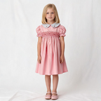 Front view of pink smocked dress. Suitable for birthdays, family gatherings, special occasions, or everyday.