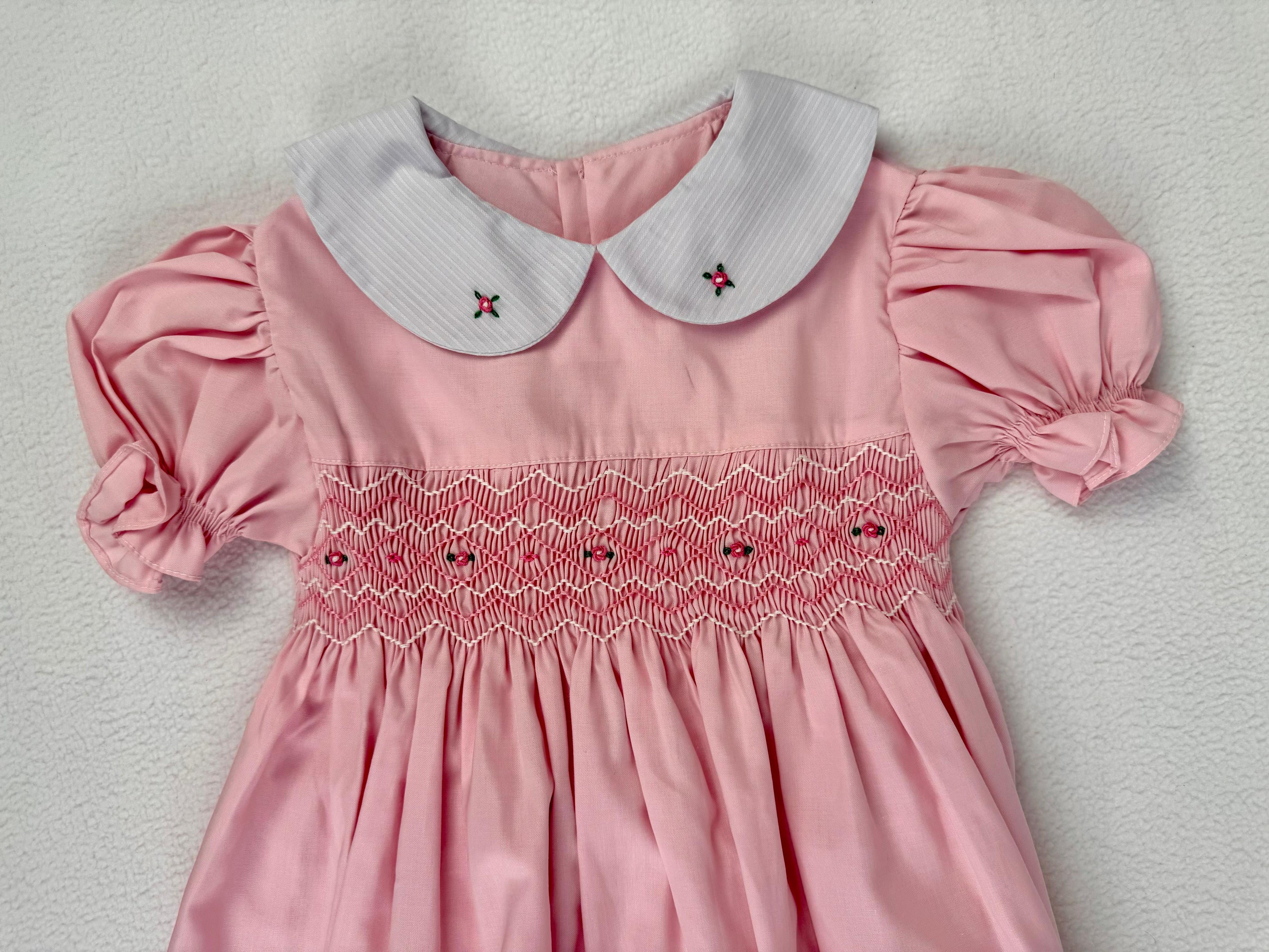Close up of pink smocked dress. Suitable for birthdays, family gatherings, special occasions, or everyday.
